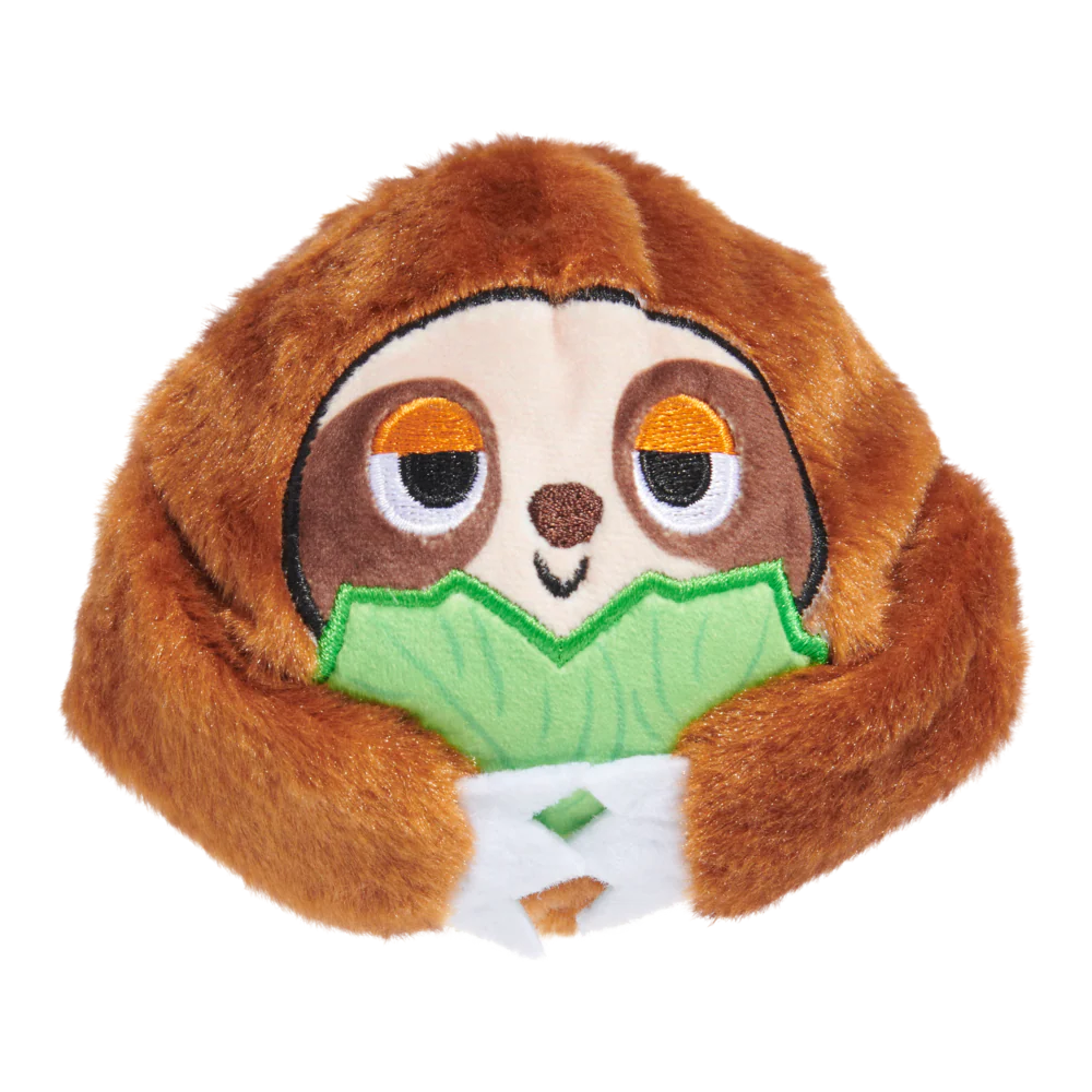 Plush toy sloth holding a leaf on a white background