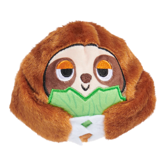 Plush toy sloth holding a leaf on a white background