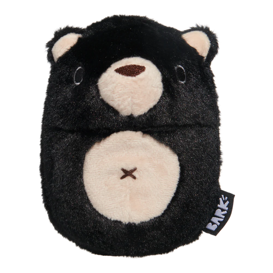 Black and beige plush toy with 'Bark' tag on a white background