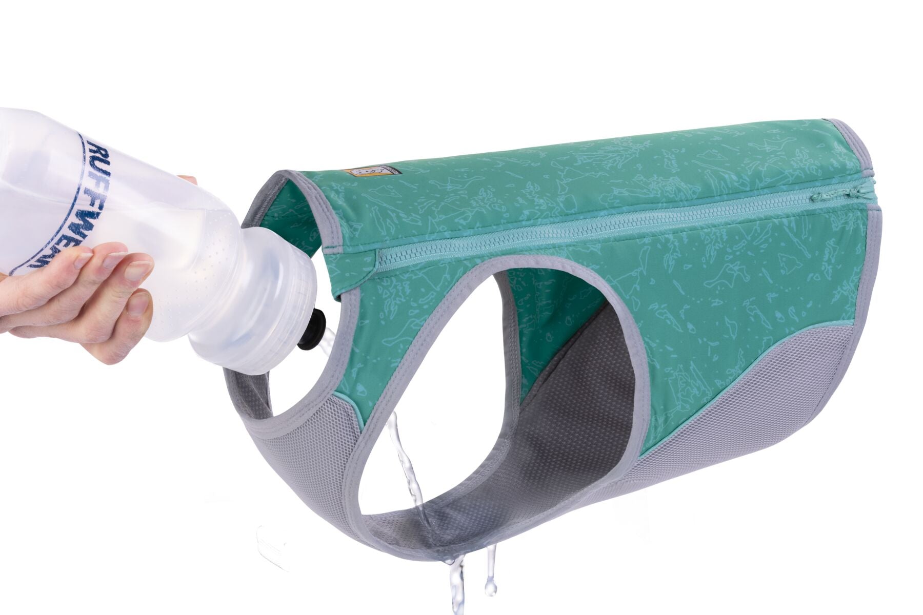 a teal ruffwear cooling vest with a bottle of water being tipped over the fabric